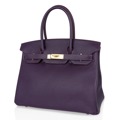 Deep Ripe Grape Textured Medium Structured Trapezoid Hand Tote With Luminous Warm Golden Twist Lock Hardware And Matching Suspended Engraved Metal Padlock Charm